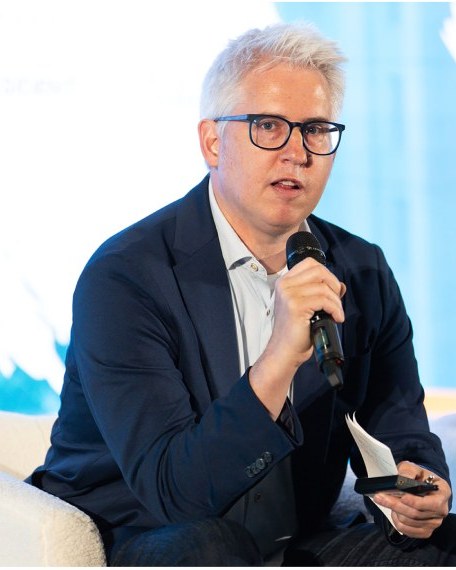 A speaker on the main stage at the conference