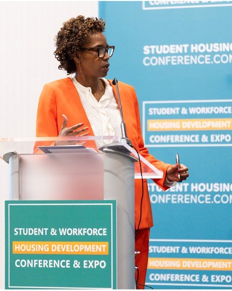 A speaker at the podium during a session